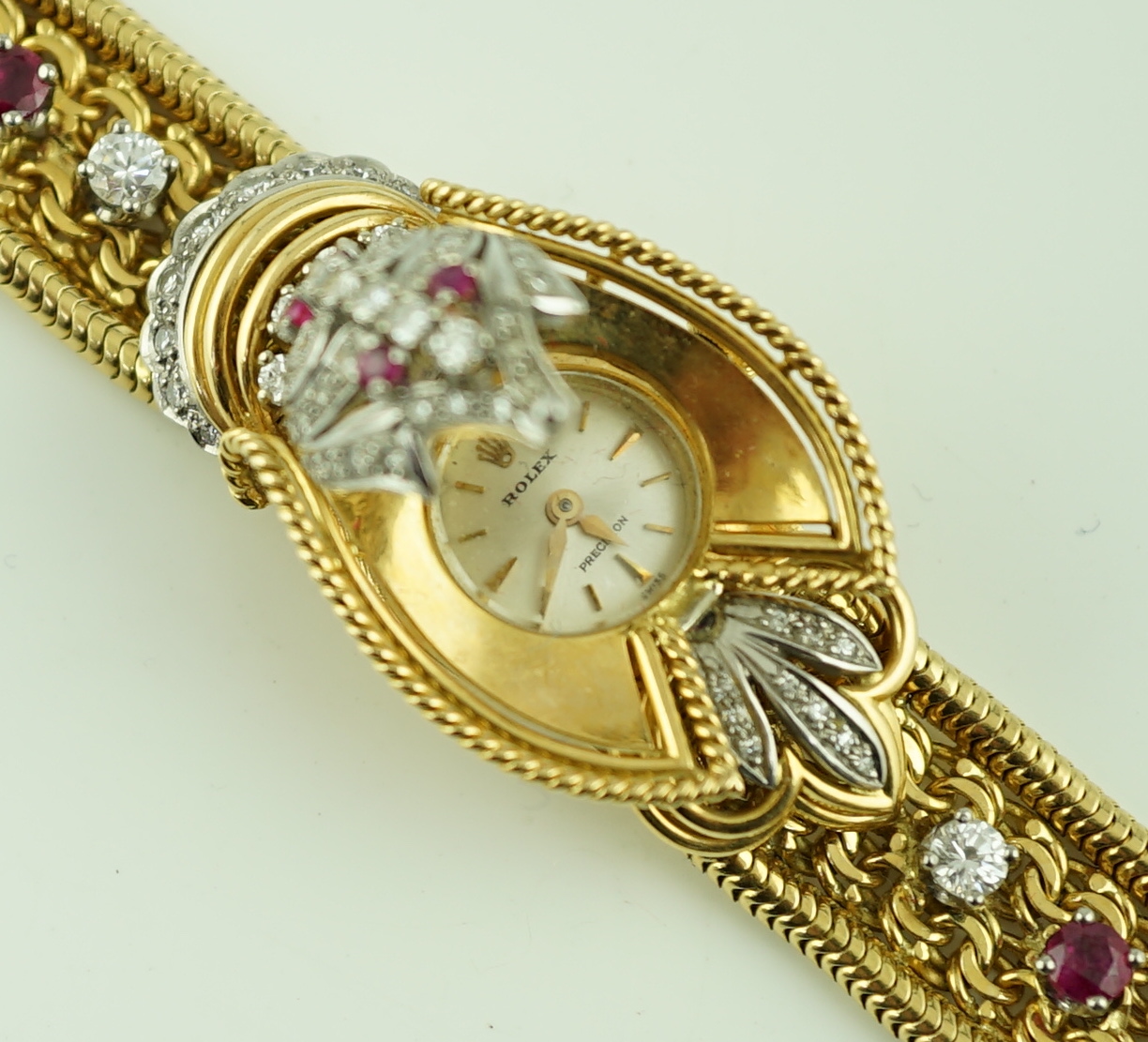 A lady's 18ct gold, ruby and diamond cluster set Rolex manual wind cocktail watch